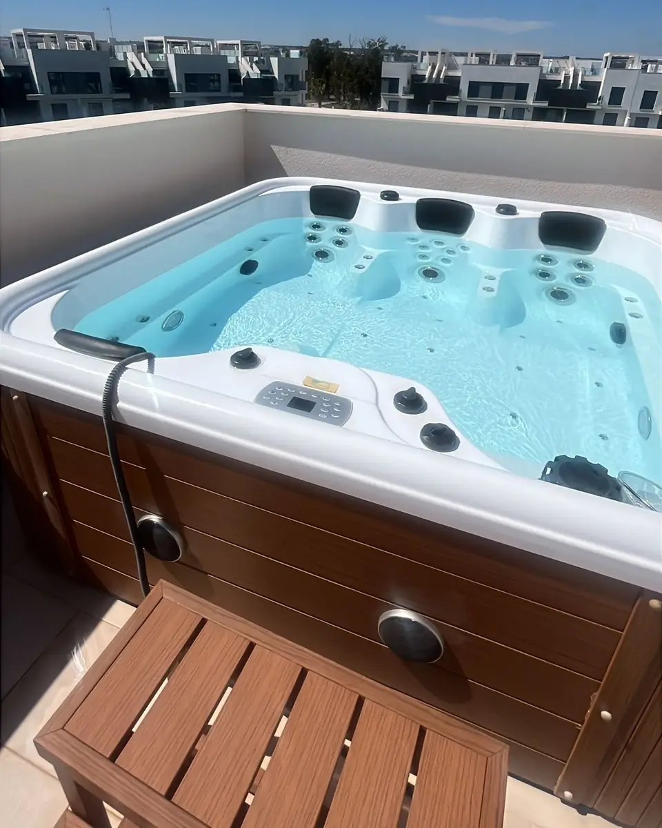 Het bubbelbad op het dakterras, met een houten trapje ervoor